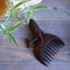 Hand-Carved Wooden Comb with Intricate Whale Design