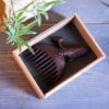 Hand-Carved Wooden Comb with Intricate Whale Design