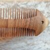 Rustic Hand-Carved Wooden Comb with Intricate Fish Design