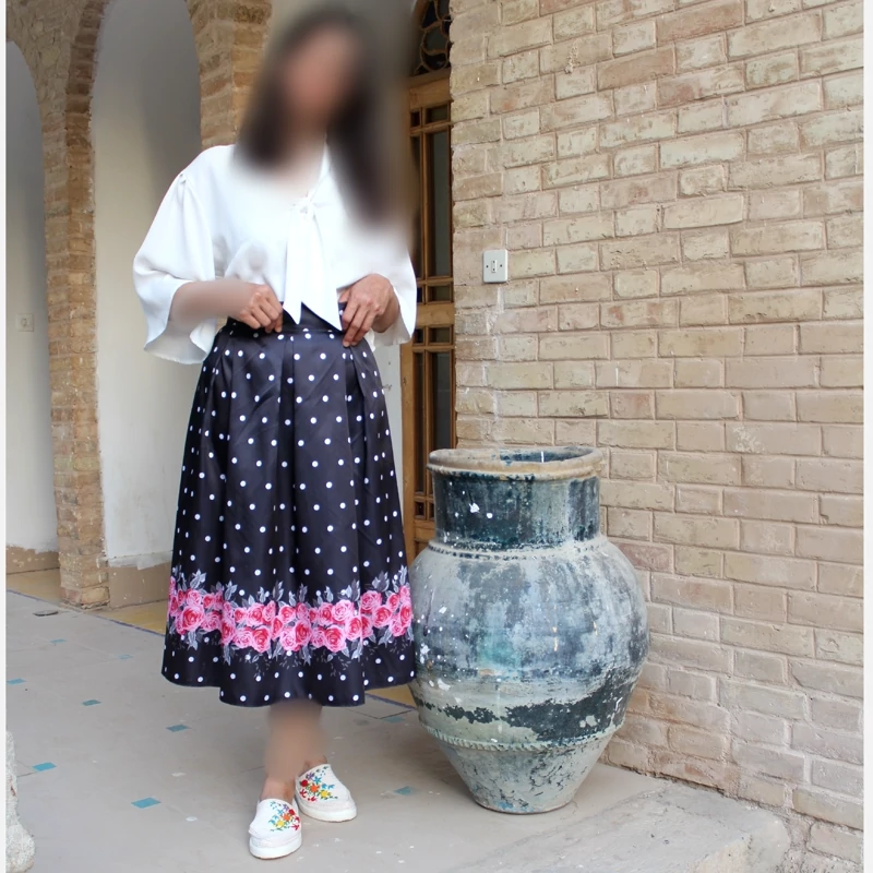 Black Pleated Satin Skirt with White Polka Dots and Bold Pink Floral Hem
