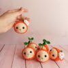 Handmade-Crochet-Orange-Keychain-–-Soft-Yarn-Bag-Charm-with-Green-Leaf-and-White-Blossom