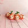 Handmade-Crochet-Orange-Keychain-–-Soft-Yarn-Bag-Charm-with-Green-Leaf-and-White-Blossom1